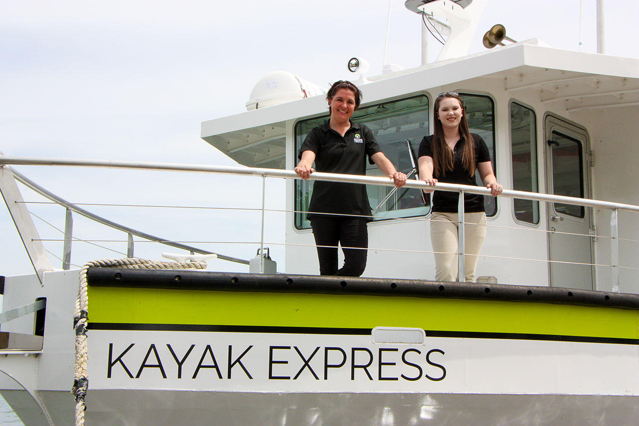 Deidre Phillipson, left, and Abby Rahn, are pictured on board the Kayak Express, Pictured Rocks Kayaking’s newest vessel.