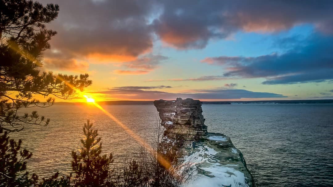 The sun setting at Miners Castle in the Pictured Rocks. PC: Munising Visitors Bureau