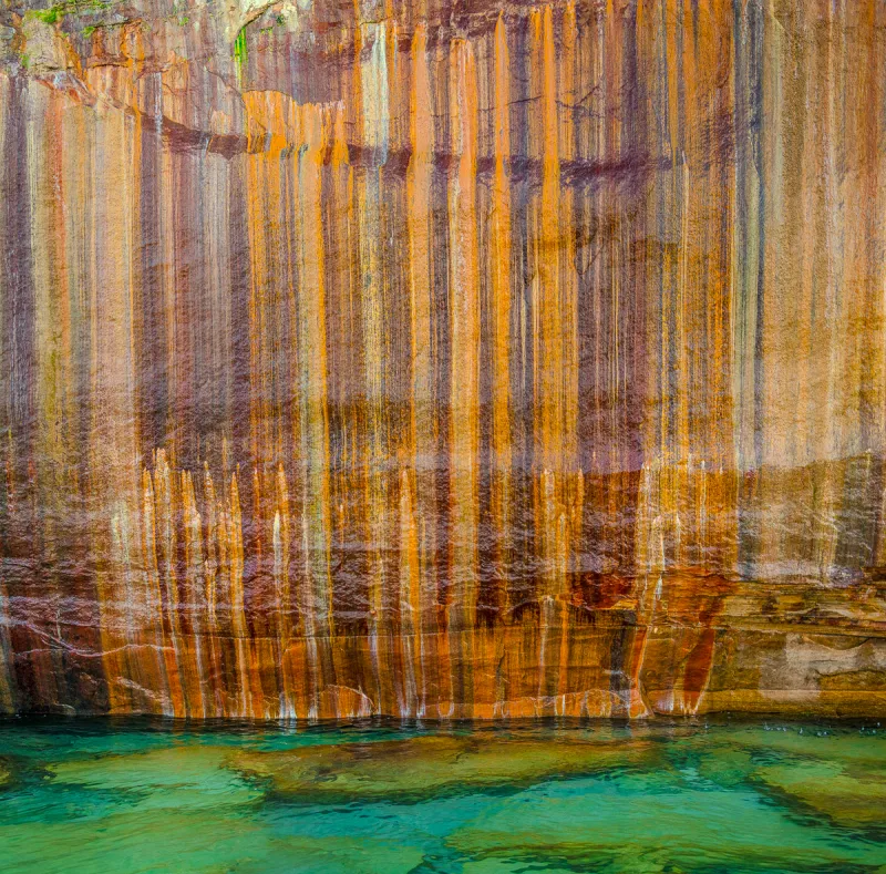 The streaks of color on the Pictured Rocks cliffs.